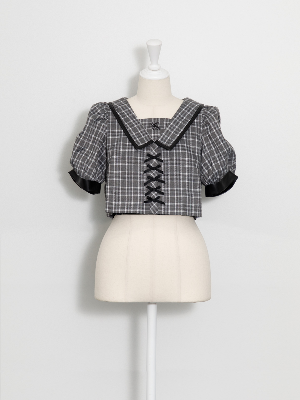 レザーパイピングフロントリボントップス