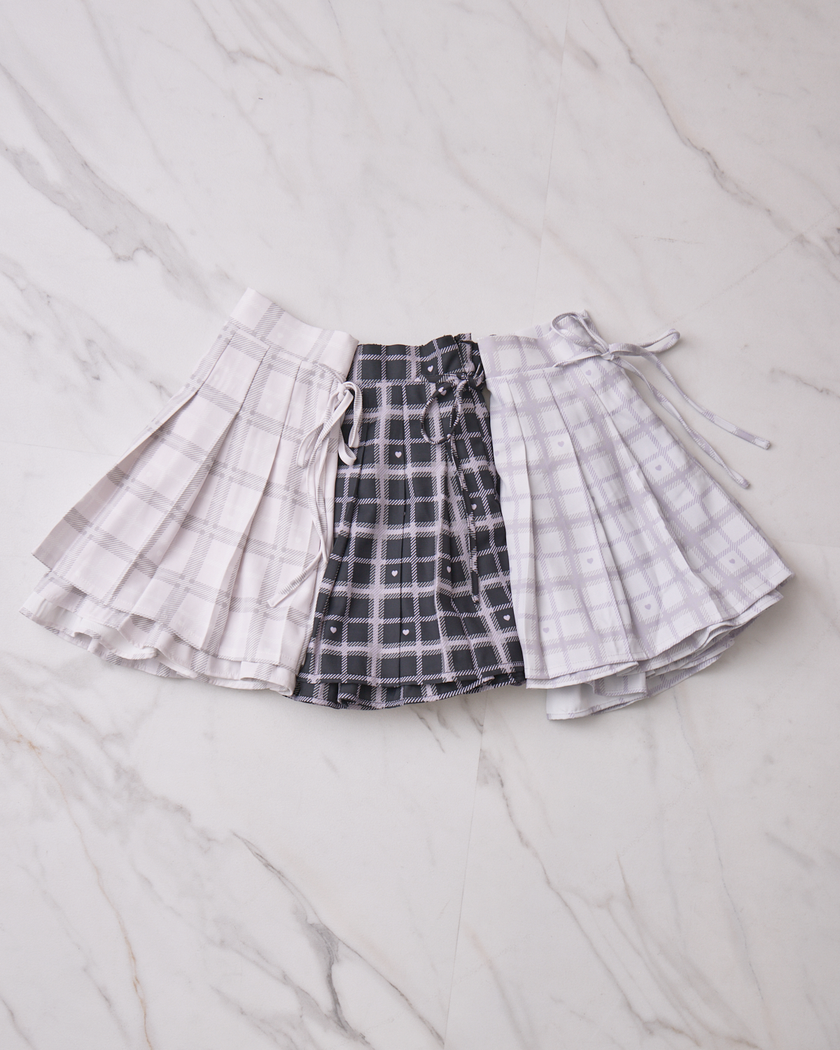 piumハートチェックサイドリボンプリーツスカート